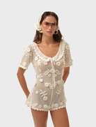 White Sara romper featuring a stylish design, perfect for casual outings or summer events