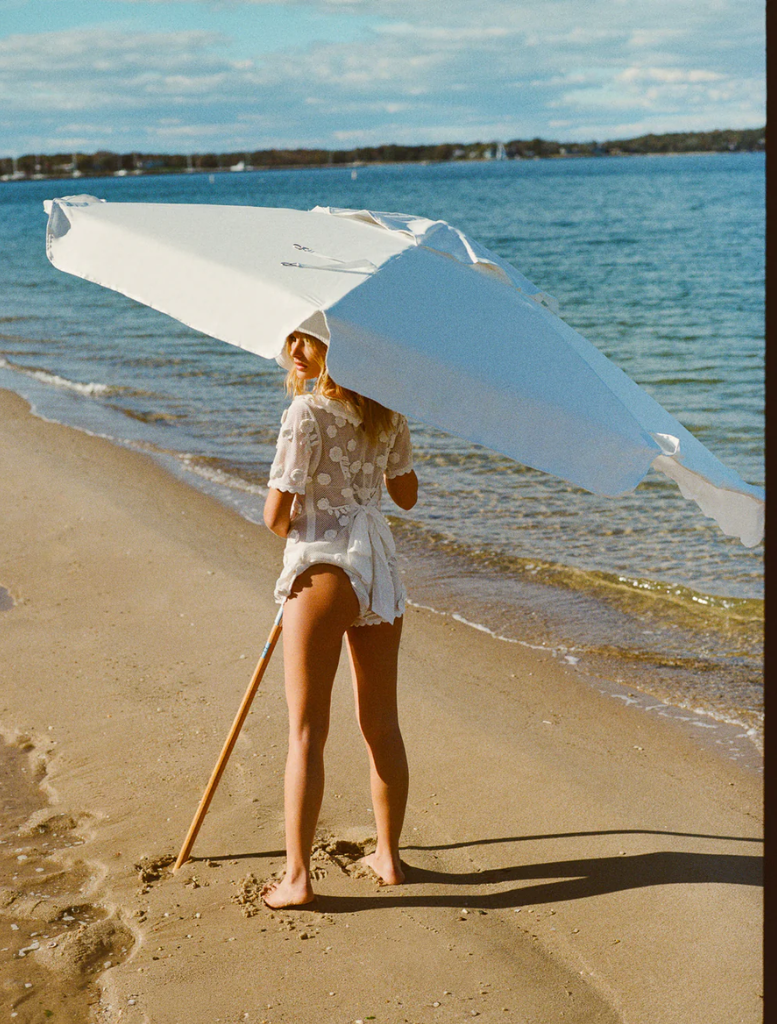 Chic white Sara romper, offering a fashionable look for casual outings or relaxed summer days.