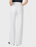 A woman models the Sasha 32 Wide Leg Jean in white, paired with a stylish striped top.