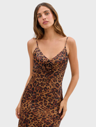 Leopard-patterned gown with rosette detailing, offering a blend of elegance and modern style for formal attire.