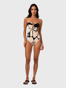 Strapless one-piece swimsuit in Botanica print, featuring a defined bust, V-wire, and vertical panel seams for a sleek look.
