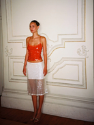 Backless burnt orange top adorned with shimmering sequins, showcasing a stylish and elegant design.