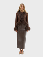 Chocolate-colored sheer blouse with feather embellishments, offering a stylish and lightweight option for formal or casual wear.