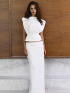 Ivory Shelly Top displayed on a hanger, featuring a simple design and soft fabric suitable for casual wear.