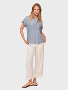 Short sleeve button-down shirt in a distressed blue wash, complete with a front pocket.