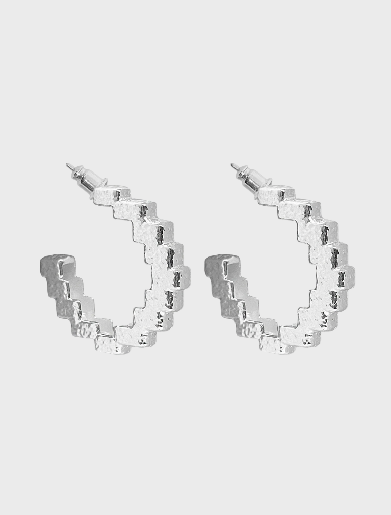 Silver Gabrielle earrings with a modern aesthetic, perfect for enhancing any outfit.
