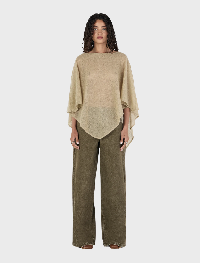 Simona Poncho in a soft pistachio hue, perfect for layering and adding a pop of color to any outfit.