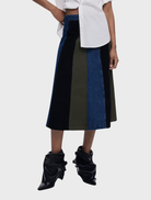 Multi-colored Evase skirt displayed on a hanger, showcasing its flowing design and vibrant patterns.