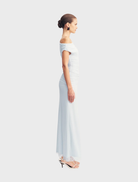 Flowing off-shoulder maxi dress in sky blue, designed for comfort and style during summer celebrations.