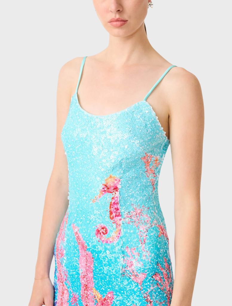 Stylish coral fitted mini dress featuring a vibrant blue and multi-colored pattern, suitable for various events.