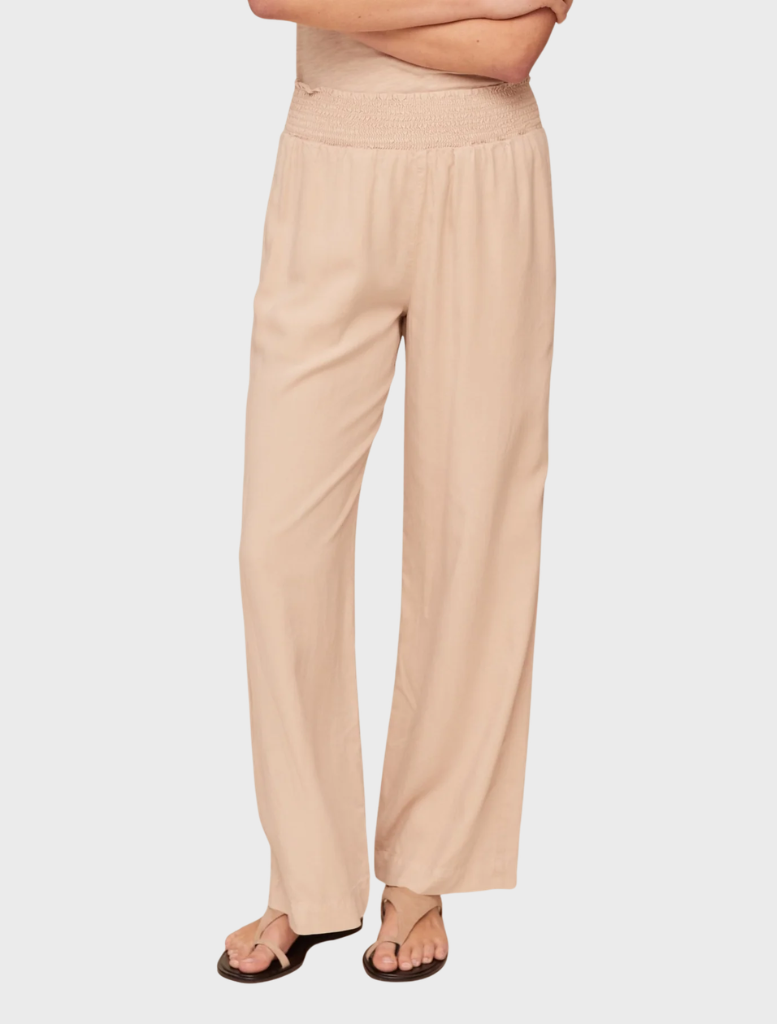 Smocked waist wide-leg pants in linen sand, featuring a relaxed fit and breathable fabric for comfort and style.