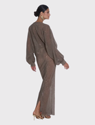 Modern gown in smoke sequin, featuring a deep neckline and voluminous sleeves, designed for a graceful and elongated look.