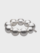 A silver bracelet adorned with numerous spherical beads, showcasing a unique and elegant design.