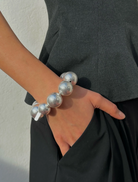 A silver bracelet featuring a multitude of spherical elements, creating a striking and textured appearance.