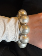  A silver bracelet embellished with a large number of spherical balls, offering a distinctive and fashionable look.