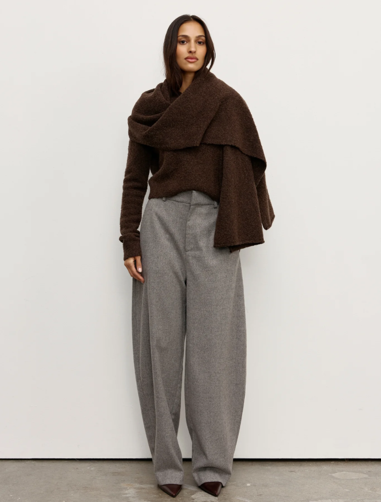 A soft, knitted scarf featuring a bear design, ideal for warmth and style during colder months.