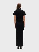 Black Evren knit top draped on a mannequin, illustrating its contemporary design and cozy material.