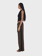A black wool top by Pip, featuring a classic cut, hanging against a neutral background.