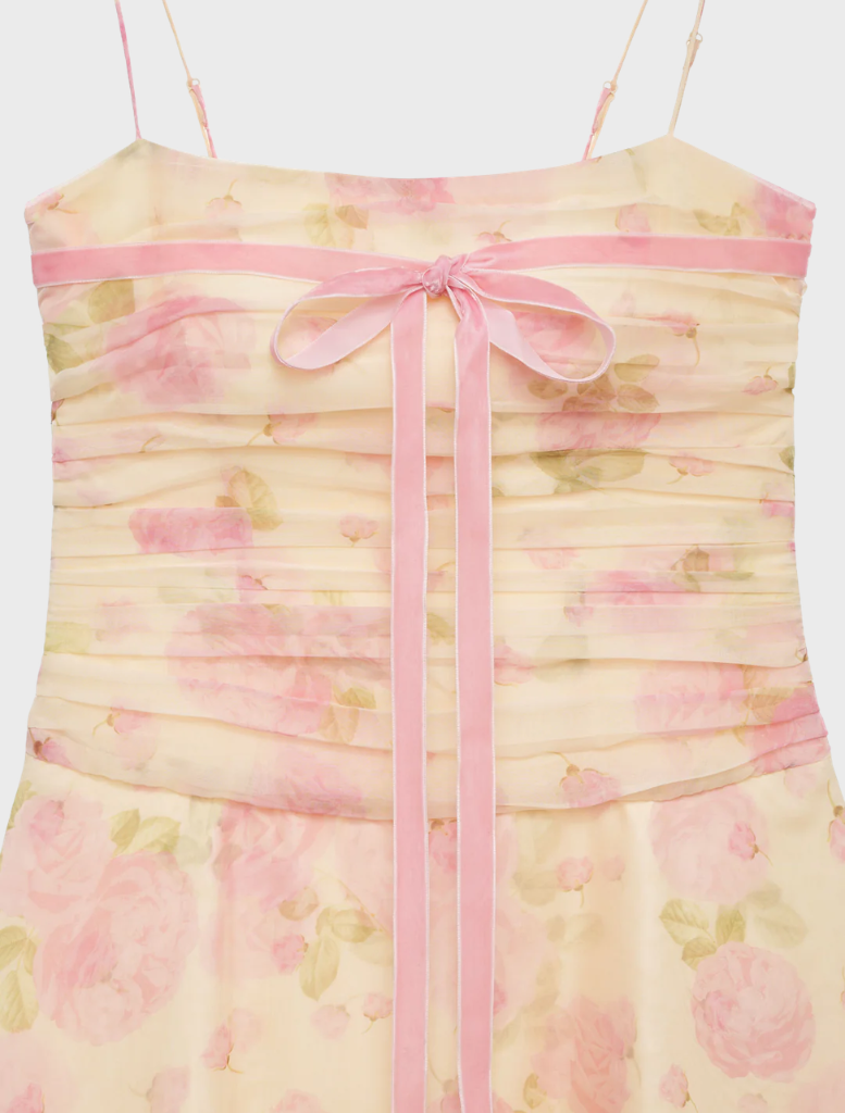 Elegant soft yellow mini dress featuring a flattering cut and thin straps, ideal for warm weather occasions.