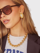 Elegant gold SOHO studs showcasing oval clear crystals, crafted with 18k gold plating and designed for sensitive ears.