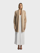 Latte-colored Sophia Open Cashmere Cardigan, featuring a relaxed fit and soft texture, perfect for layering in cooler weather.