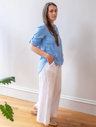 Close-up of a tidal blue split back button-down shirt, emphasizing its color and distinctive style.