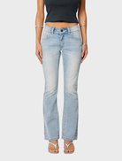 A woman models the 99 Boot - Stella, wearing jeans and a stylish crop top.