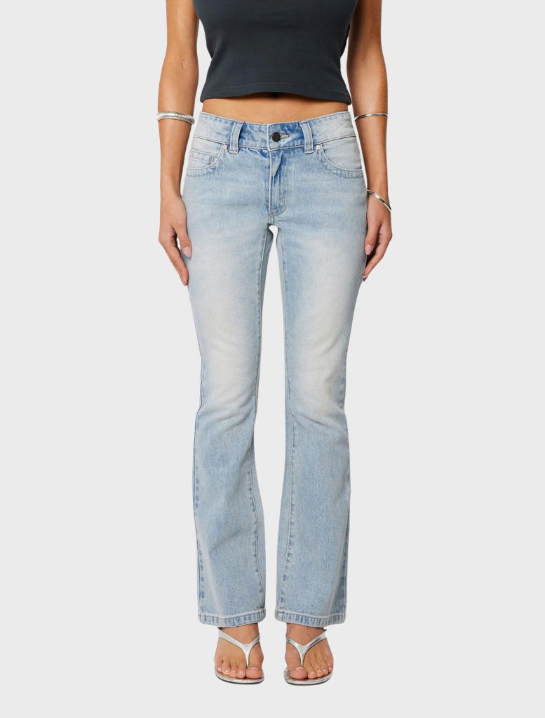A woman models the 99 Boot - Stella, wearing jeans and a stylish crop top.