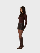 Chic vegan leather shorts in dark truffle, ideal for a fashionable and environmentally conscious wardrobe.