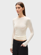 Ivory top designed by Stevie, showcasing a contemporary cut and versatile style for casual or formal wear.