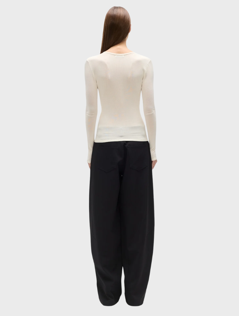 Stevie's ivory top, characterized by its sophisticated design and soft fabric, perfect for both day and evening wear.