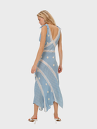 Blue midi dress adorned with a dot design, showcasing short sleeves and a tailored silhouette for versatile styling.