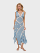 A blue midi dress featuring a dot pattern, with short sleeves and a fitted waist, ideal for casual or semi-formal occasions.