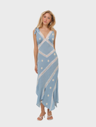 Stylish blue midi dress with a dotted pattern, featuring short sleeves and a cinched waist, perfect for day or evening wear.