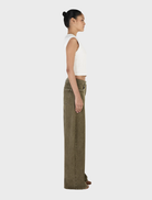 Khaki Paige Denim jeans shown on a flat surface, illustrating their tailored fit and classic denim style with detailed stitching.