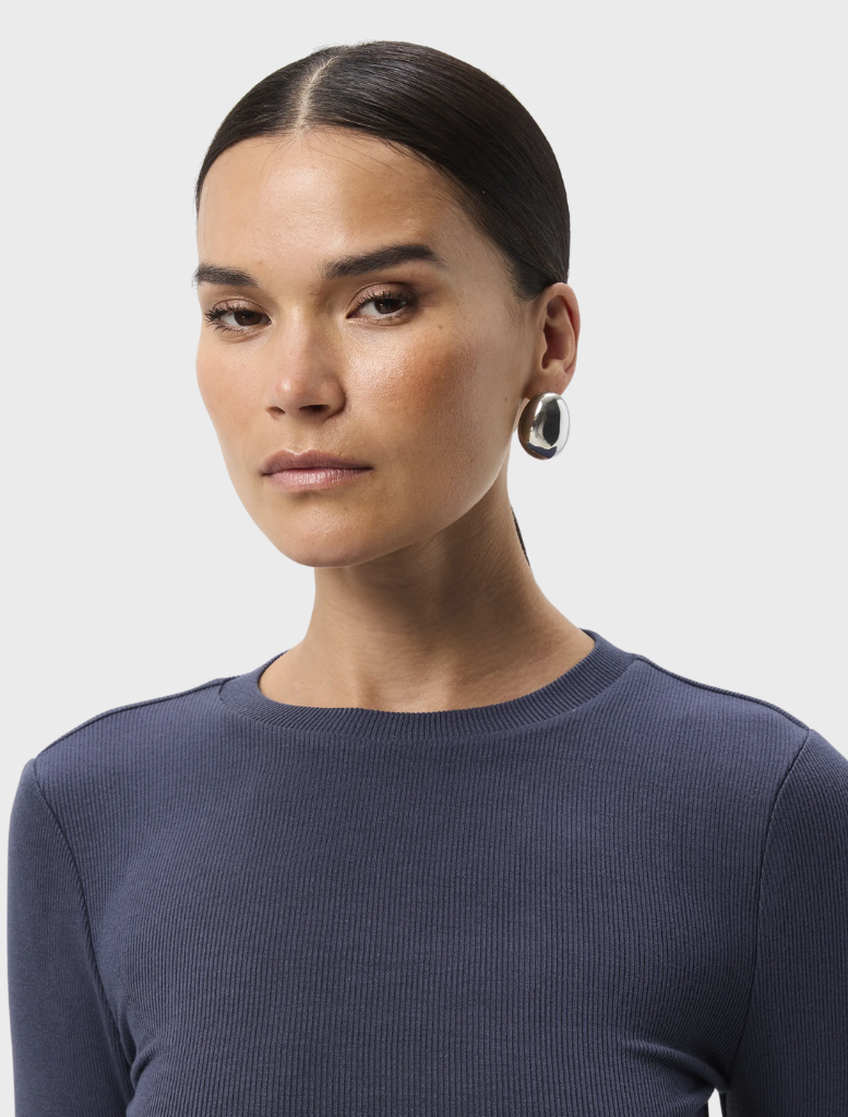 A sapphire blue top with a sleek design, featuring a round neckline and short sleeves, perfect for casual or dressy occasions.