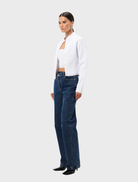  White Carter Cardigan presented on a hanger, emphasizing its classic style, long sleeves, and comfortable fabric.