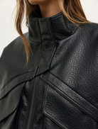 Black Inez Jacket displayed on a mannequin, featuring a sleek design and modern silhouette suitable for various occasions.