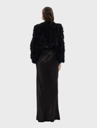 Modern black crop jacket by Manhattan, showcasing a tailored fit and versatile style for various occasions.