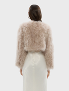 Blush Manhattan crop jacket presented, featuring a fashionable cut and soft fabric for a sophisticated appearance.