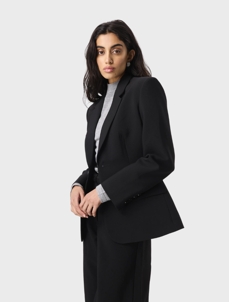 Black Sonder Blazer showcased on a hanger, highlighting its chic design and versatility for various occasions.