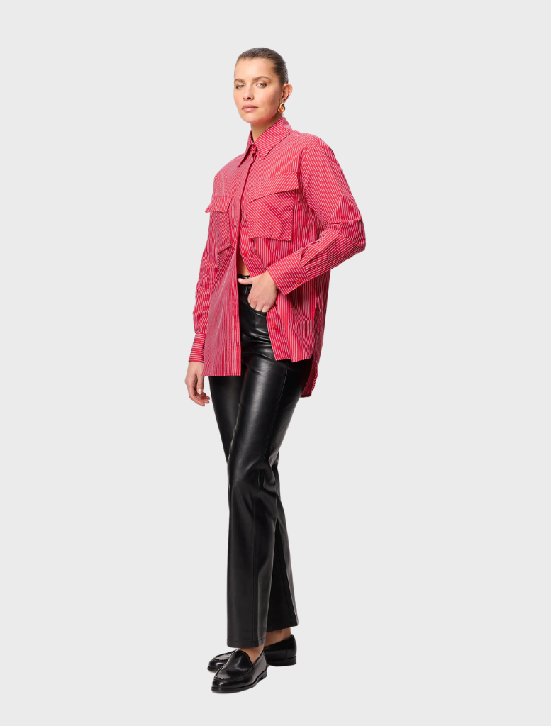 A red striped Tudor shirt folded neatly, featuring distinct stripes and a refined appearance.