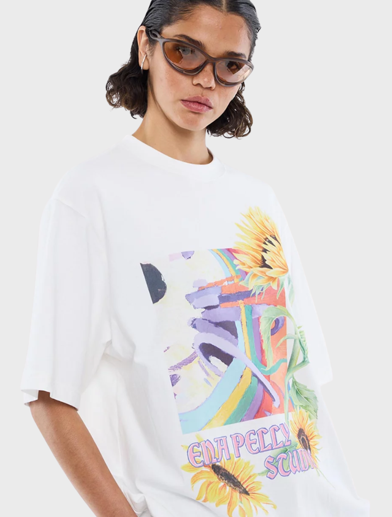 Vintage white t-shirt displaying a colorful sunflower graphic, suitable for everyday wear and a touch of nature-inspired style.