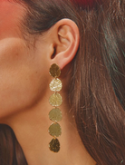 Elongated gold drop earrings with hand-hammered texture, lightweight design, and 9.2 cm drop length.