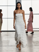 Elegant strapless dress in a soft milk hue, featuring a fitted top and a gently flared skirt for a chic look.