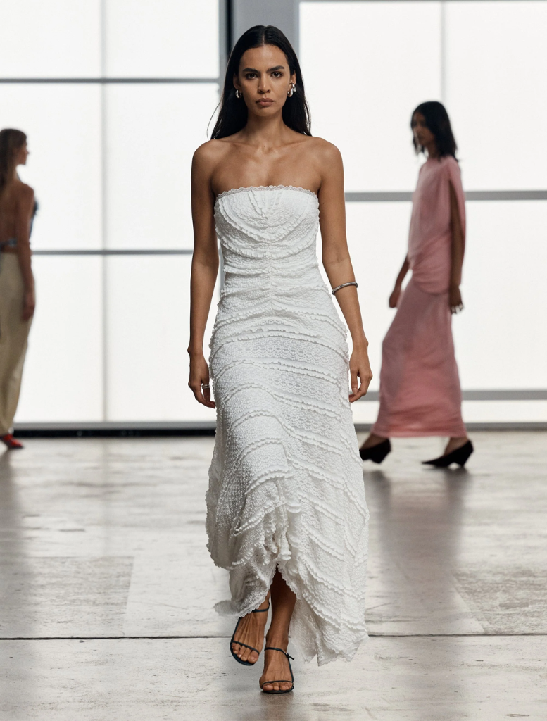 Elegant strapless dress in a soft milk hue, featuring a fitted top and a gently flared skirt for a chic look.