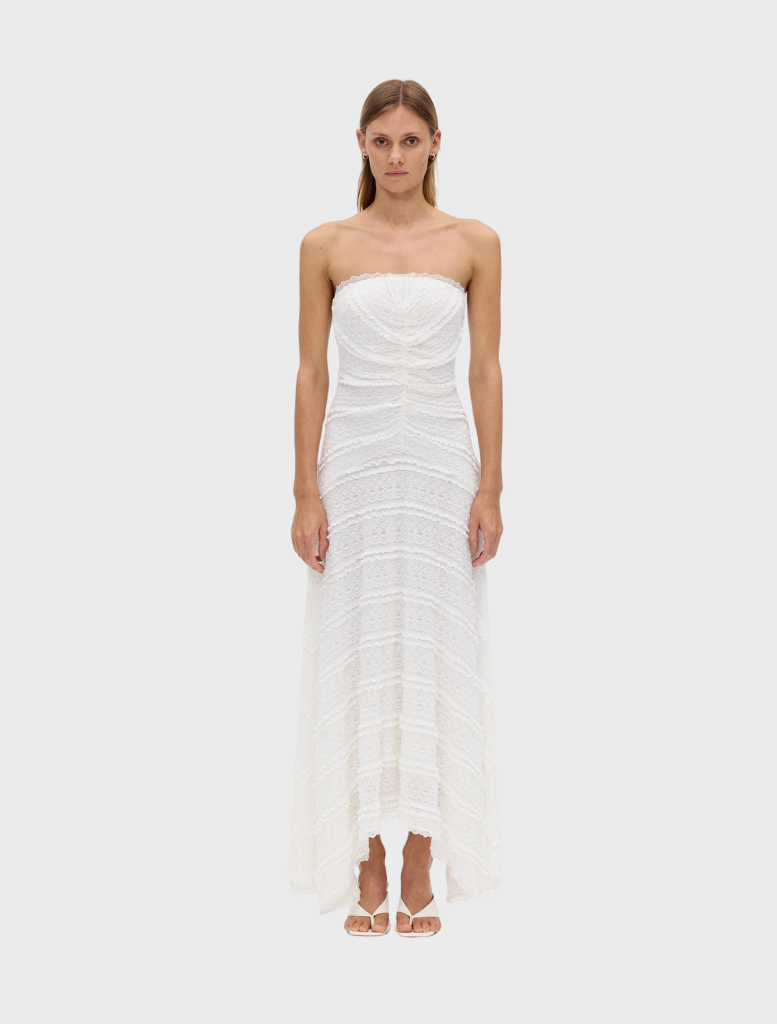 Strapless milk-colored dress with a fitted bodice and flowing skirt, perfect for summer events or casual outings.