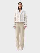 Cream Talamasca jacket displayed on a hanger, featuring a stylish design suitable for various occasions.