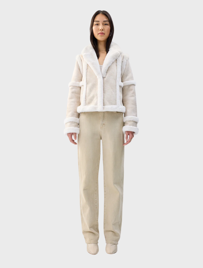 Cream Talamasca jacket displayed on a hanger, featuring a stylish design suitable for various occasions.