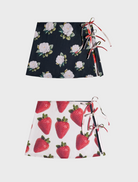  Two skirts featuring strawberry patterns, one with a flared design and the other with a fitted silhouette.